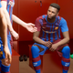 A soccer player stares sadly at his teammates.